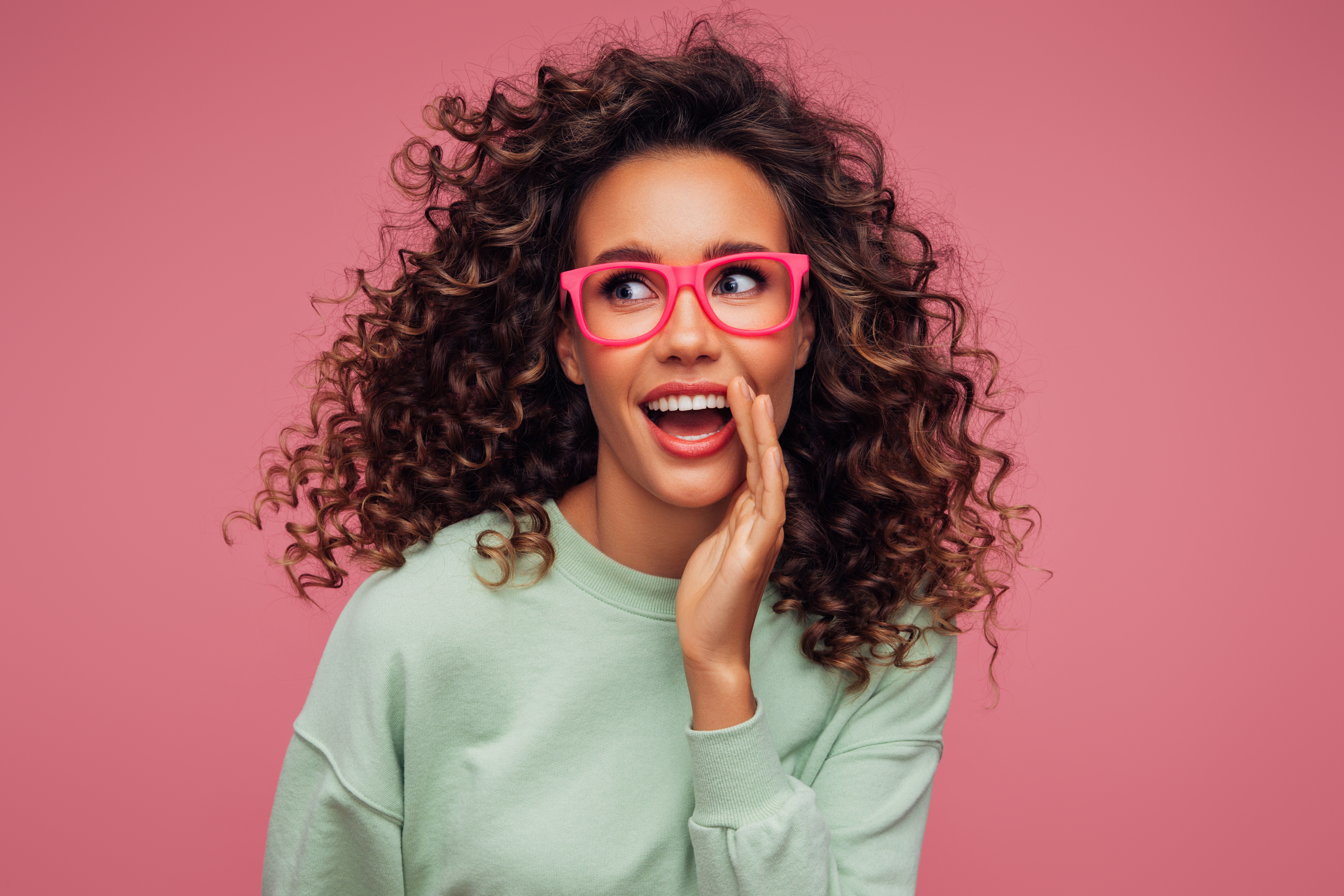 Smiling person wearing premium pink frames